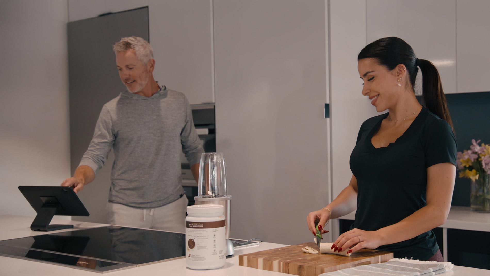 Man and woman using a tablet in a smart kitchen