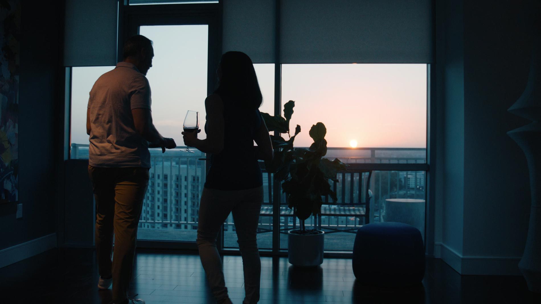 Couple enjoying a sunset view from their home