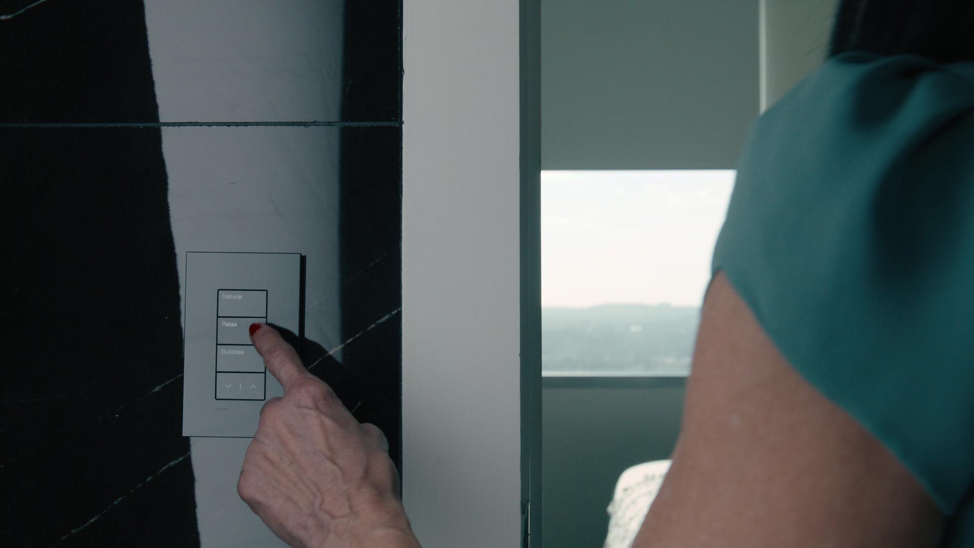 Woman pressing a button on a smart home control