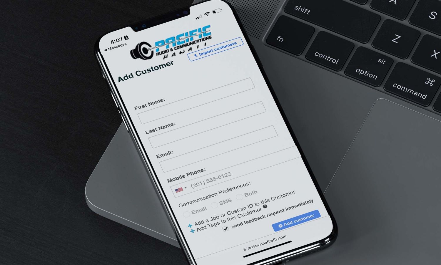 cell phone with mockup lying on a grey macbook